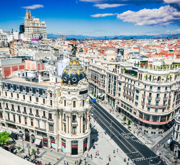 The vibrant cityscape of Madrid, Spain, showcasing the renowned bullring as a central element in the background.